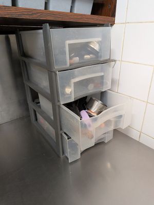 a shelf with three drawers on it in a bathroom