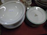 many plates and bowls sitting on a table together