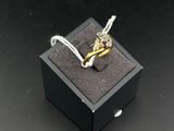 an image of a gold ring in a black box on a black surface