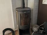 a black chair in front of a stove in a room