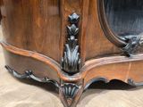 a wooden cabinet with a mirror on top of it