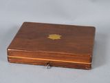 a small wooden box with a gold apple on it