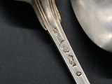 a silver spoon and a silver spoon on a black table