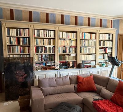 a living room with a couch and a large book shelf