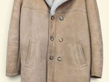 jacket on a hanger on a white wall with a black hanger