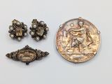 three pieces of silver and pearl jewelry including a coin, broochle, and a broochle