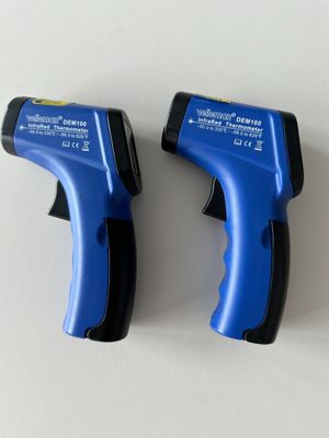 deux pistolets à colle bleus et noirs posés sur une surface blanche