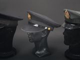 three hats are lined up on top of a mannequin head