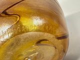 a close up of a golden vase with a small hole in it