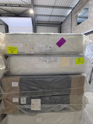 several boxes of mattresses stacked on top of each other in a warehouse