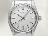 une photo d'une montre Rolex argentée avec un cadran blanc