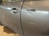 a silver car with a sticker on the side of it