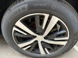 the tire of a black car with a white stripe on it