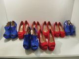 several pairs of red and blue shoes are lined up on a shelf