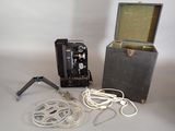 an old camera and a box with cords on a table