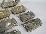a lot of toy tanks that are sitting on a table