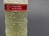 a white vase that has a red label on it