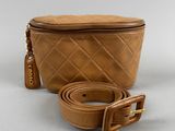 a brown bag with a belt on a white background
