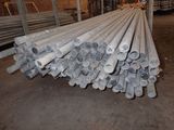 a pile of steel pipes stacked up in a warehouse