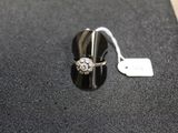 a close up of a ring on a black surface with a price tag