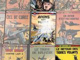 a lot of comic books on the table together
