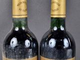 two bottles of wine are sitting next to each other on a table