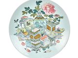 a plate with a picture of a teapot and other things on it