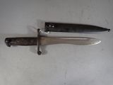 two knives that are laying next to each other on a table