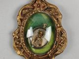 an image of a gold frame with a picture of a woman in a green dress