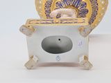 a figurine of a baby in a basket on a table