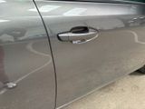 a close up of a car door handle with a sticker on it