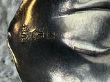 a silver spoon with a silver handle sitting on a table
