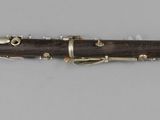 a close up of a clarinet on a table with a white background