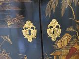 a black and gold cabinet with gold decorations on it