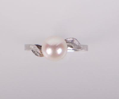 a close up of a pearl ring on a white background