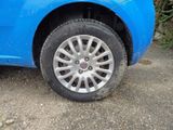 a blue car that has a flat tire on it