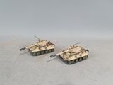 two toy tanks sitting on top of a table next to each other