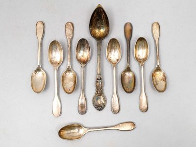 de nombreuses cuillères et cuillères à soupe disposées sur une table