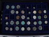 a case full of coins sitting on a table