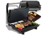 a close up of a grill with meat and vegetables on it