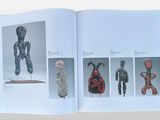 an open book with a picture of a sculpture on it