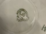 a white plate with a green design on it
