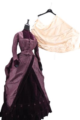 a dress on a hanger next to a dress on a mannequin