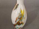 a white vase with a multicolored design on it