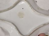 a person holding a small white plate with a star design on it