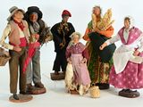 five figurines of people dressed in traditional clothing