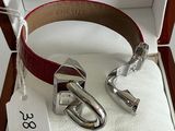 a red belt and a silver buckle in a box