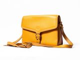 yellow leather cross body bag with strap on a white background