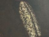 portrait of a man in a black coat and a white and gold tie