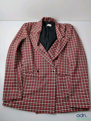 red and white checkered blazer with black tie on a hanger